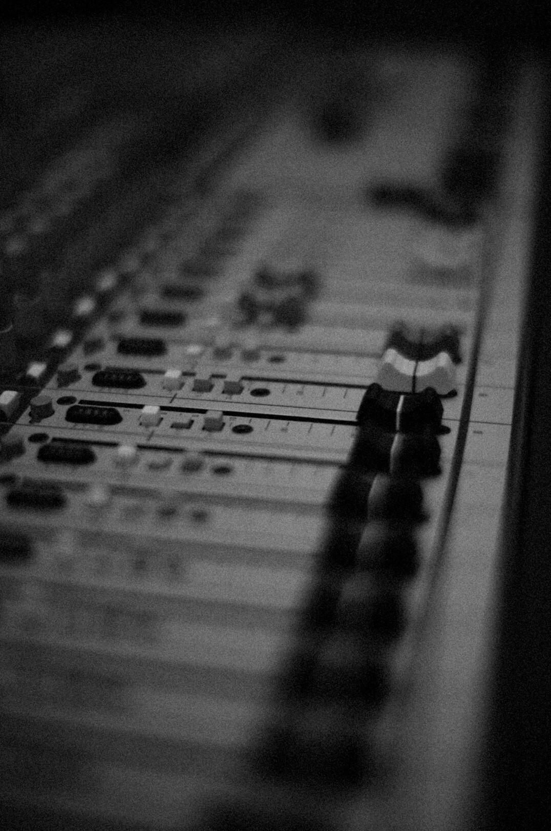 Sound engineer mixing audio at a post-production mixing console